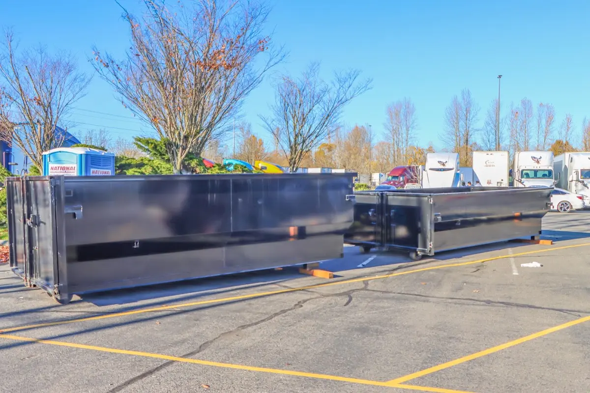 Professional dumpster rental service with roll-off container on residential driveway in Bay Point